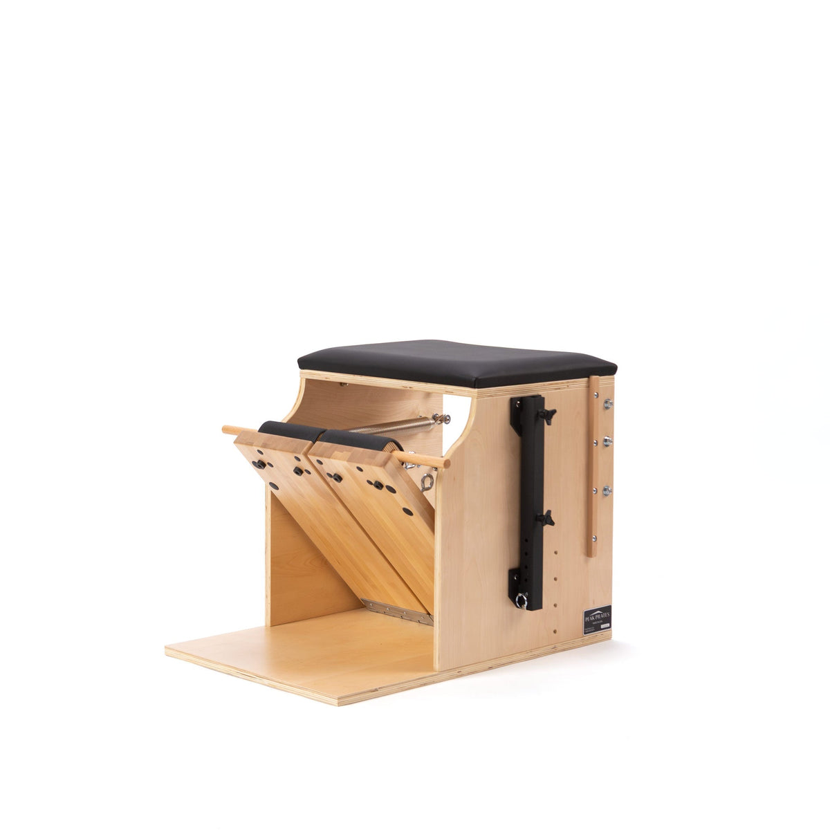 Peak Pilates Artistry Split Pedal Low Chair in light wood with a black upholstered seat and wooden base