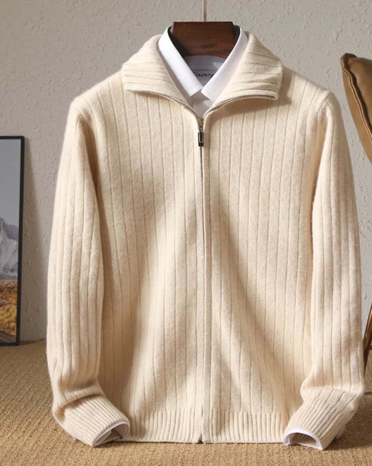 Cream ribbed merino cardigan on a wooden hanger