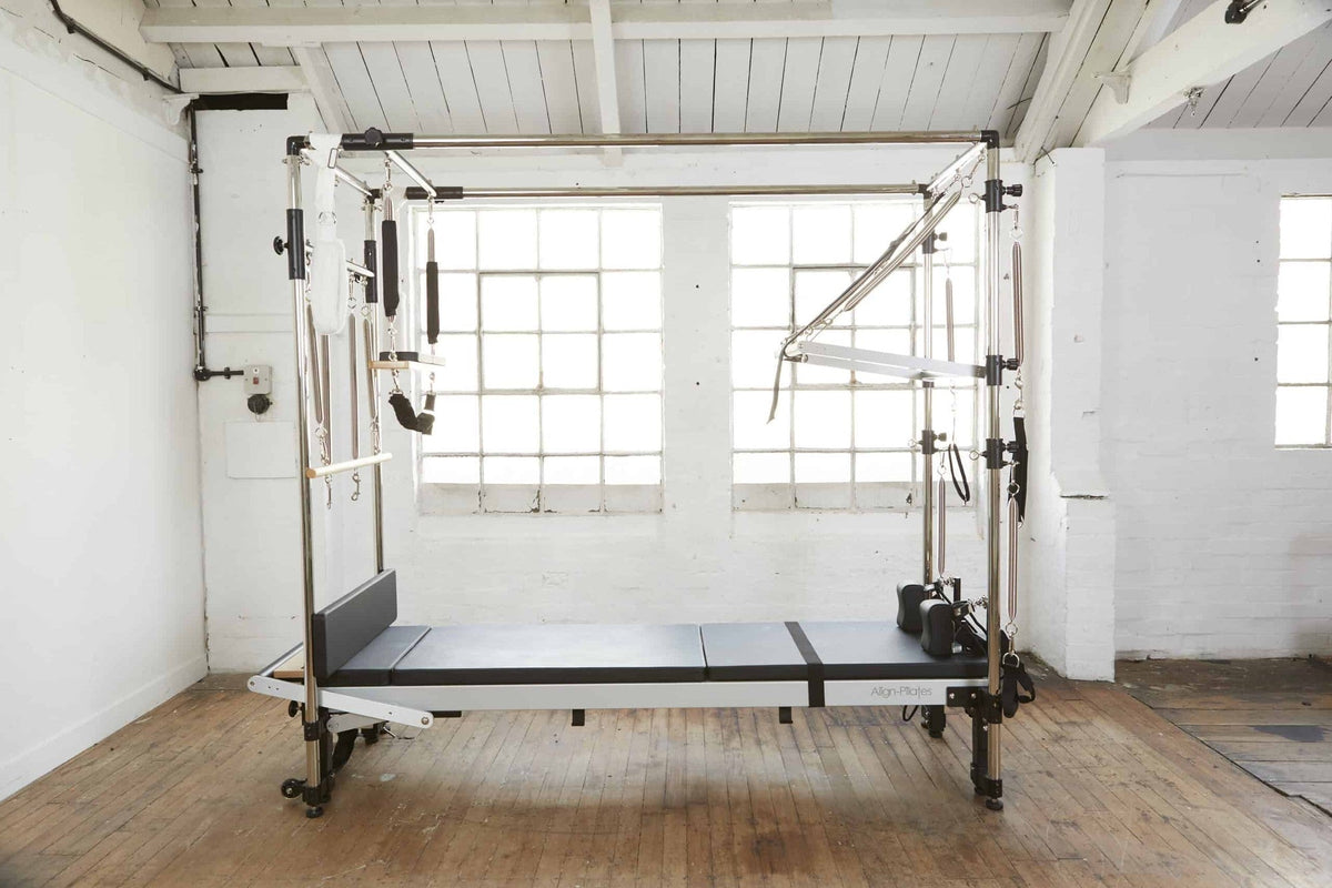Align Pilates C8-Pro with Full Cadillac, frame and reformer in a white brick studio