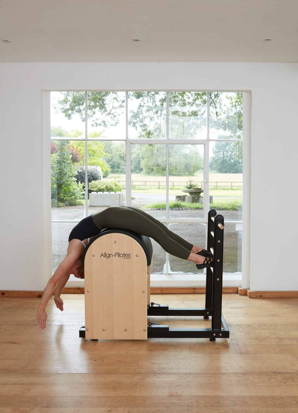 Align Pilates Ladder Barrel RC, woman in a back extension over the barrel