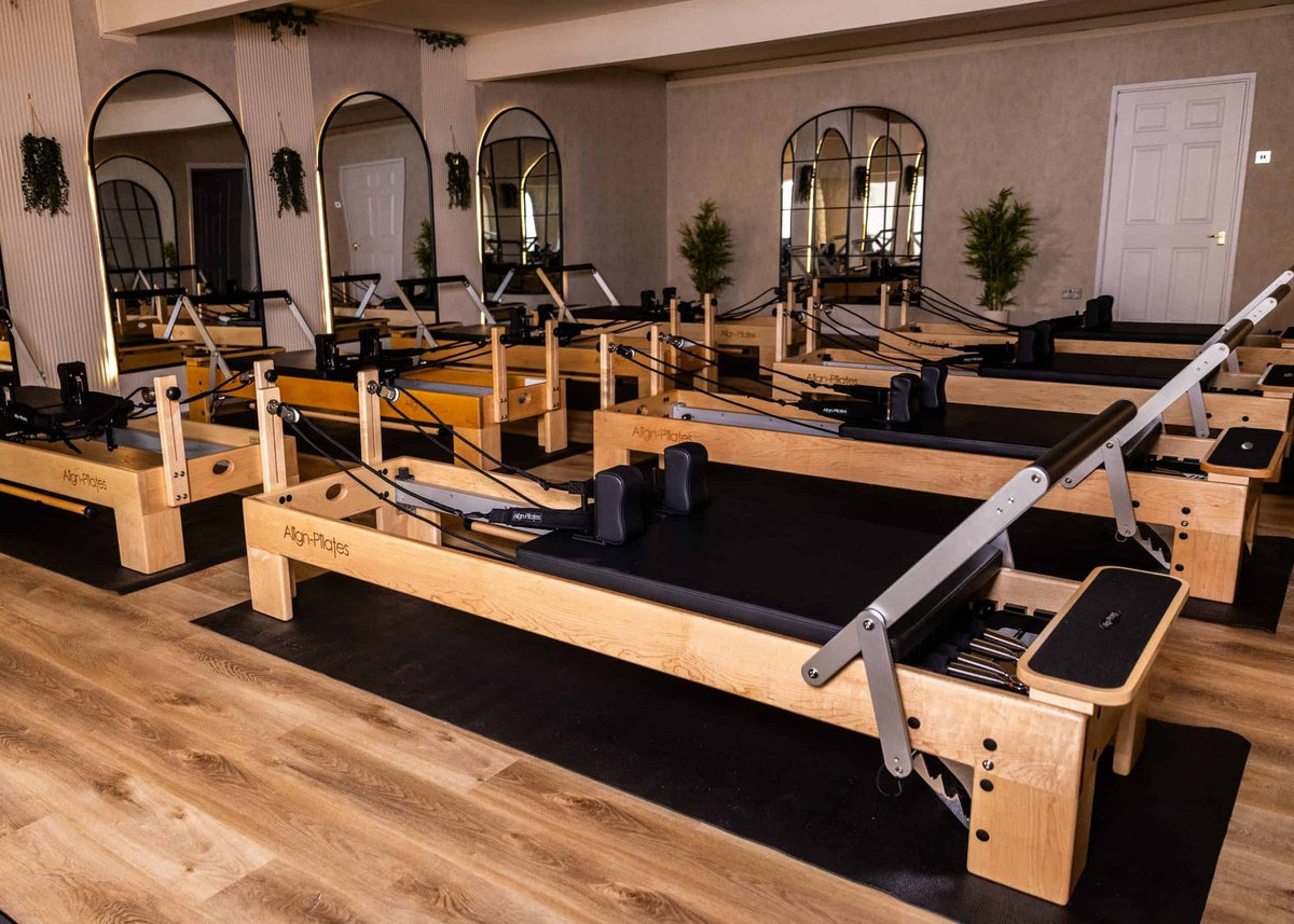 Align Pilates M8-Pro, row of maple reformers in a studio