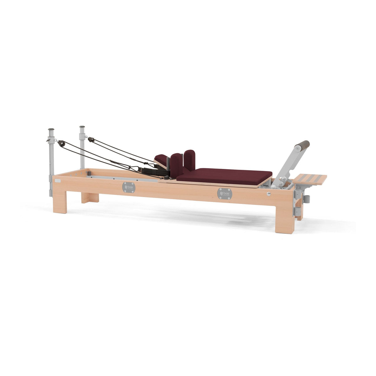 BASI Systems Compact Reformer upholstered in Burgundy, the whole apparatus shown against a plain background