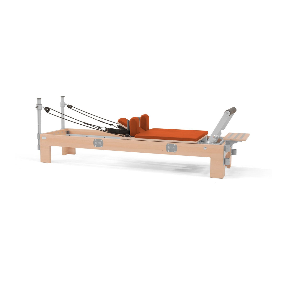 BASI Systems Compact Reformer upholstered in Campfire Orange, the whole apparatus shown against a plain background
