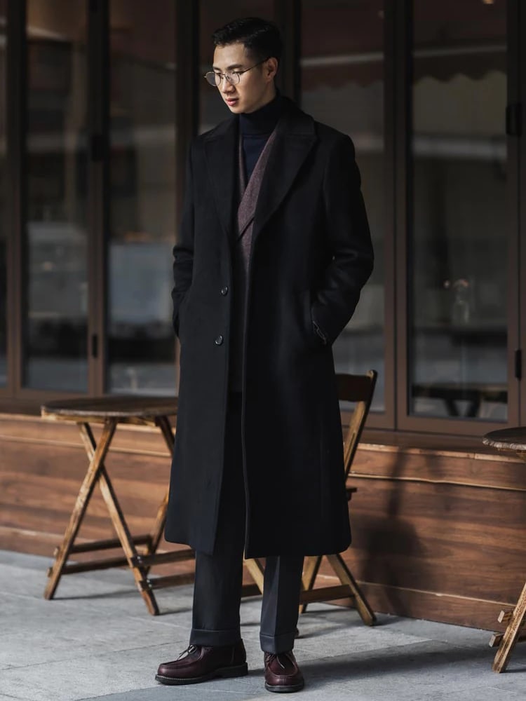 Man wearing the Ashford overcoat in black over a black turtleneck