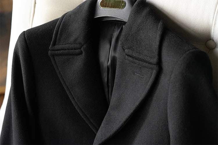 Notch lapel and lining of the Ashford overcoat on a hanger