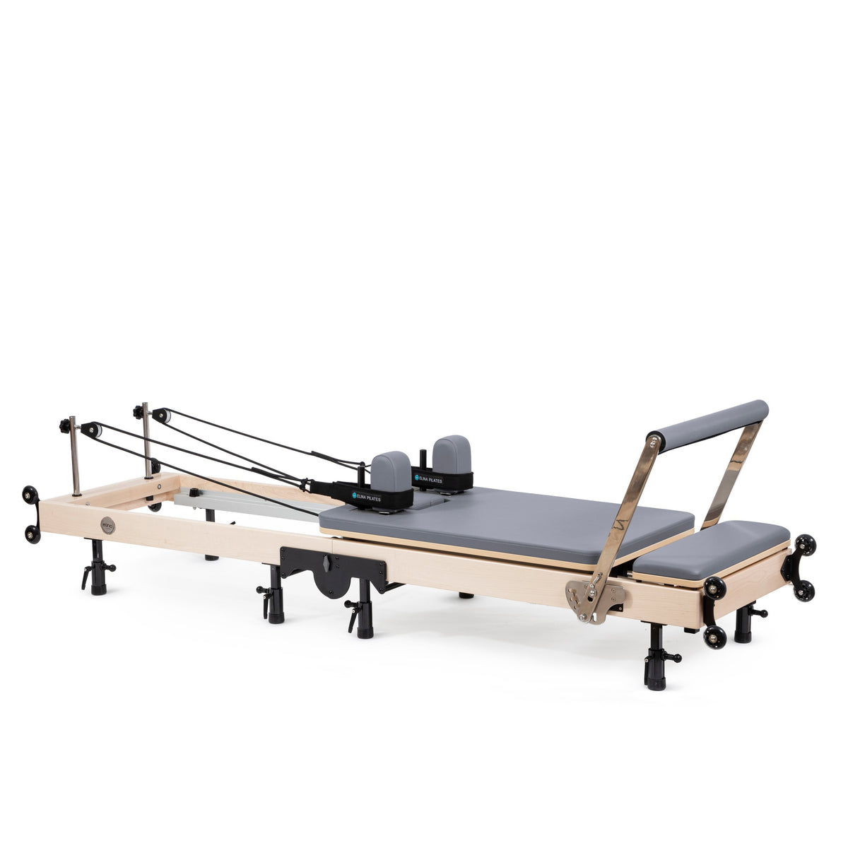 Elina Pilates Fold Reformer set up, maple frame with grey upholstery, angled view