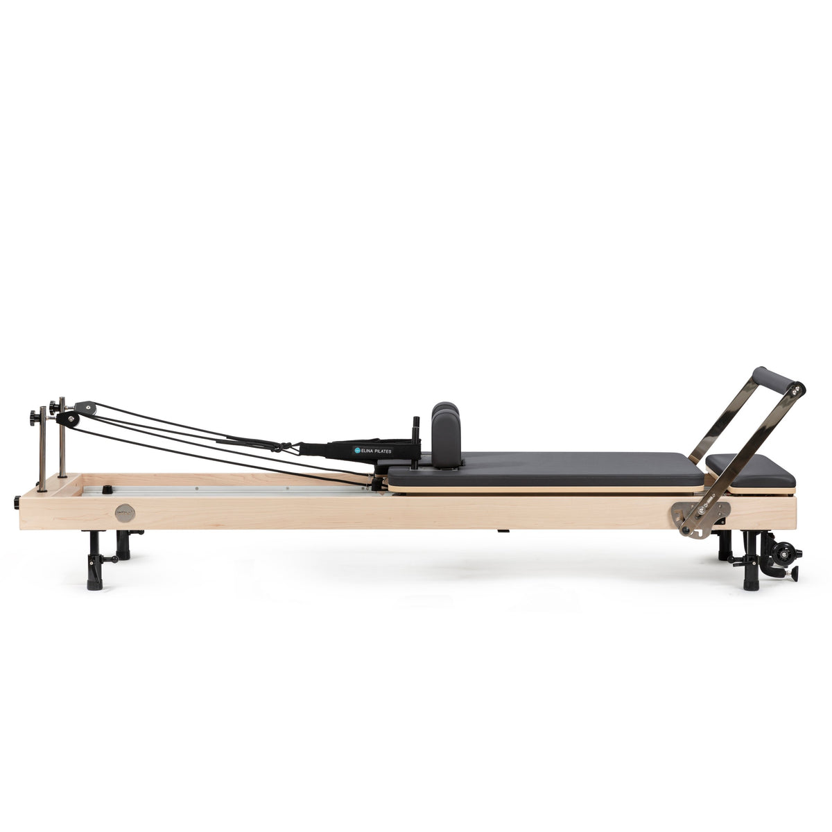 Elina Pilates Vertical Reformer set up flat, maple frame with black upholstery, side view