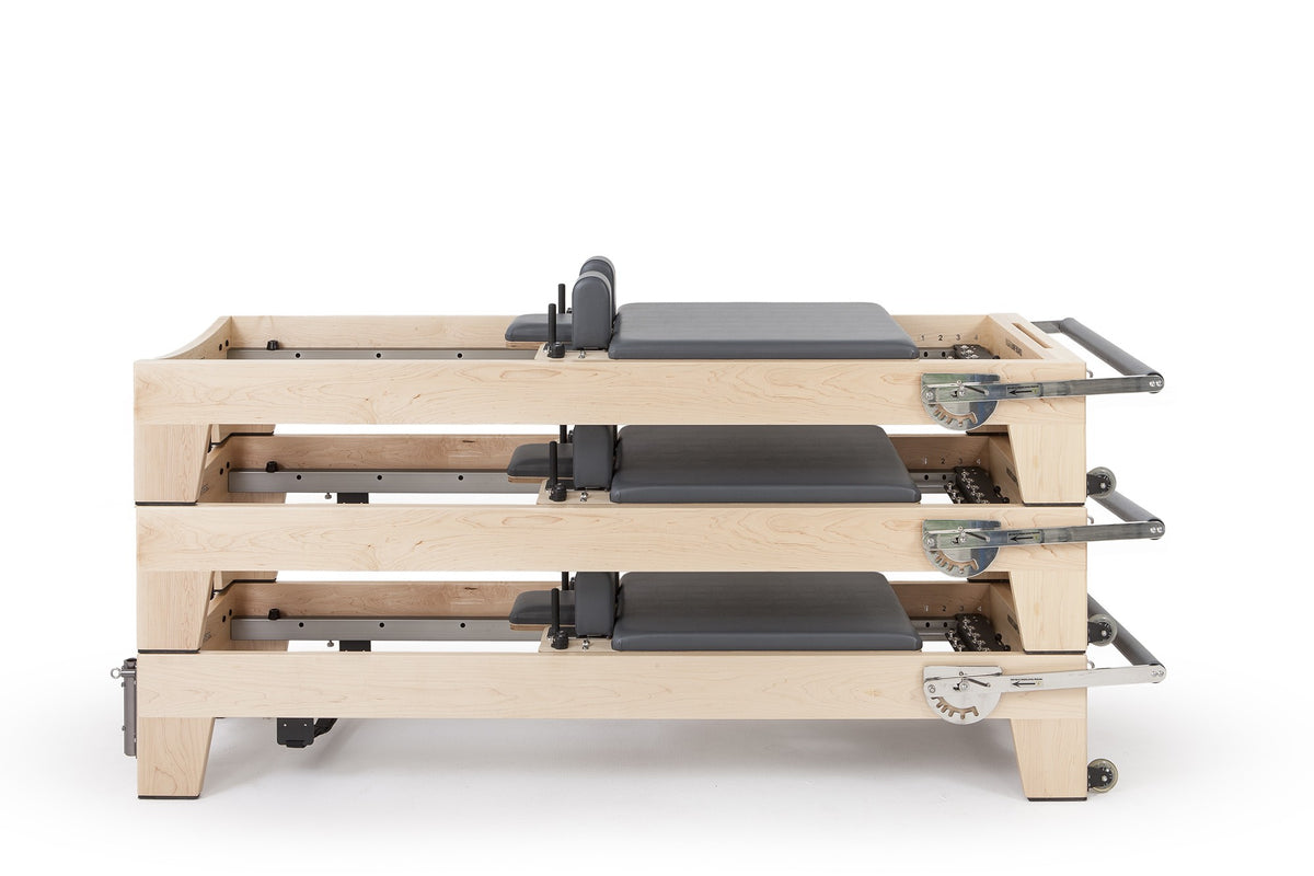 Two Elina Pilates Elite Wood Reformers stacked, grey upholstery
