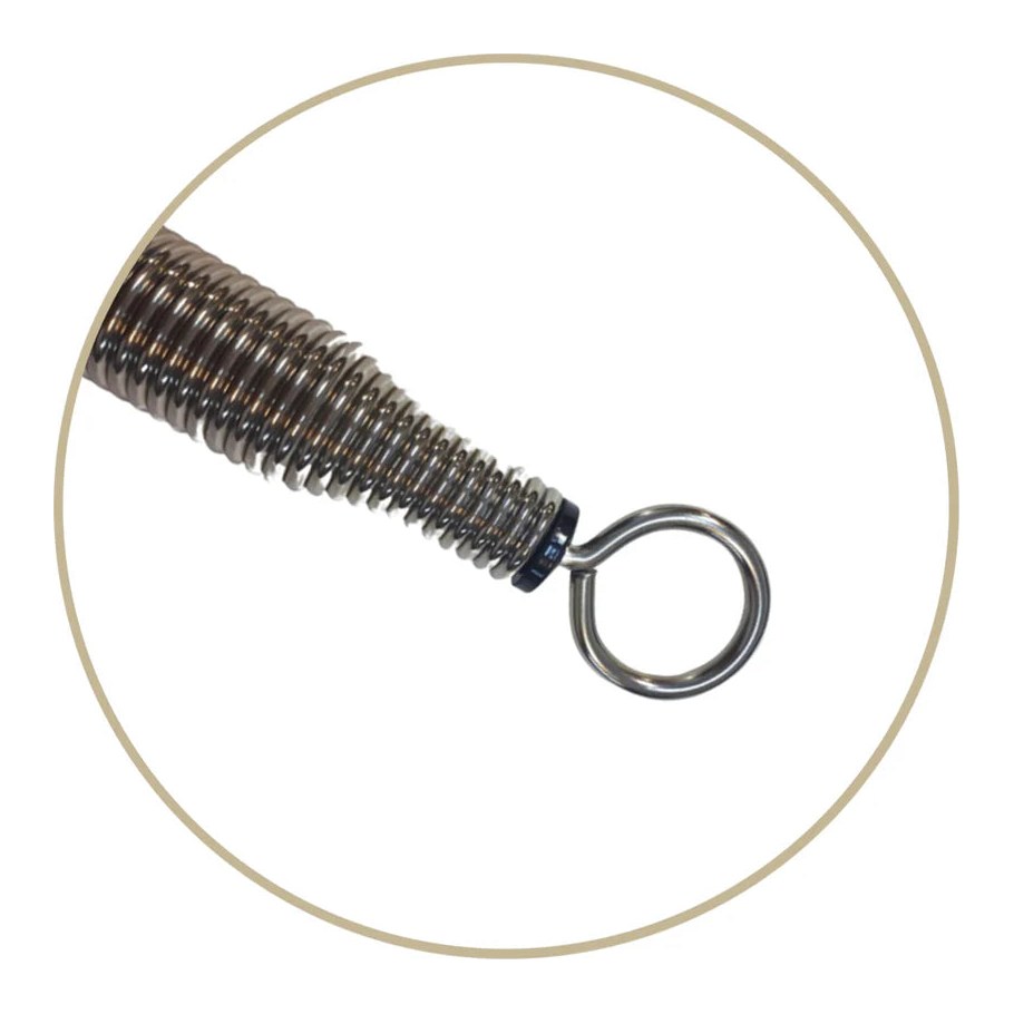 Close view of a Pilates reformer spring showing the tapered steel coil and its eye hook