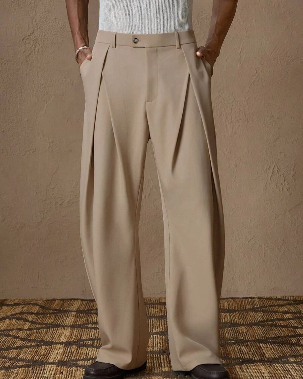 Man in stone pleated trousers