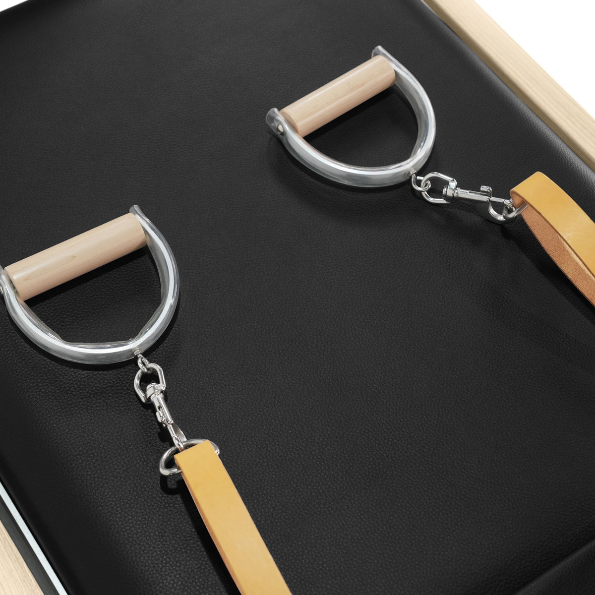 D-ring handles with wooden grips and tan leather straps, black pad
