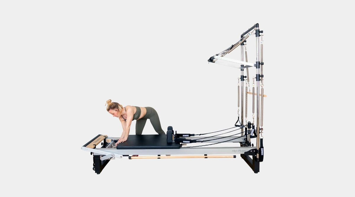 Align Pilates A8-Pro with Half Cadillac, side view with a user kneeling on the carriage