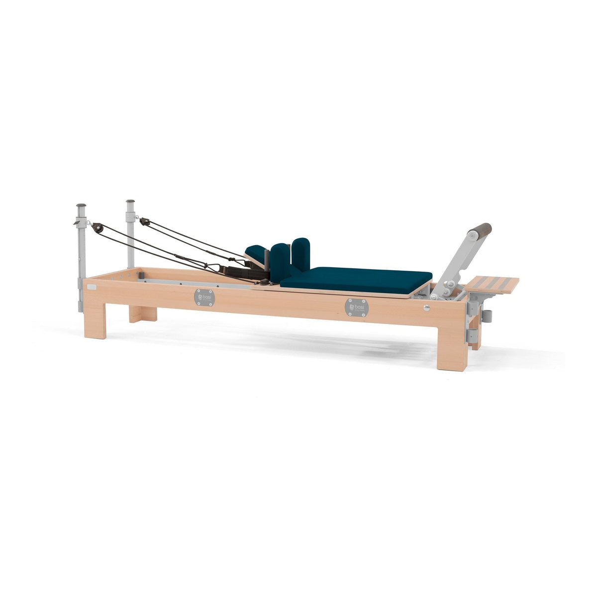 BASI Systems Compact Reformer upholstered in Petrol Green, the whole apparatus shown against a plain background