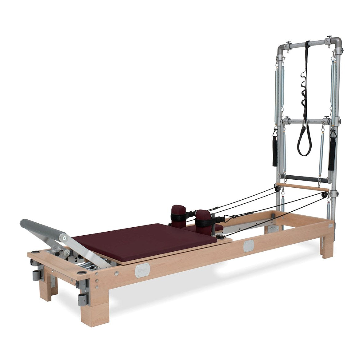 BASI Systems Reformer with Tower upholstered in Burgundy, the whole apparatus shown against a plain background