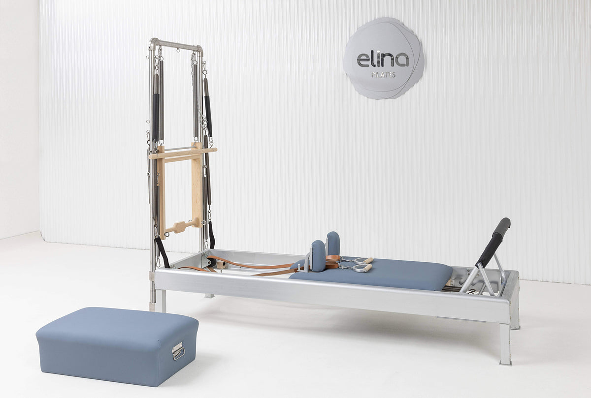 Classic Aluminium Reformer with Tower and sitting box in blue upholstery, showroom setting — made-to-order colourway