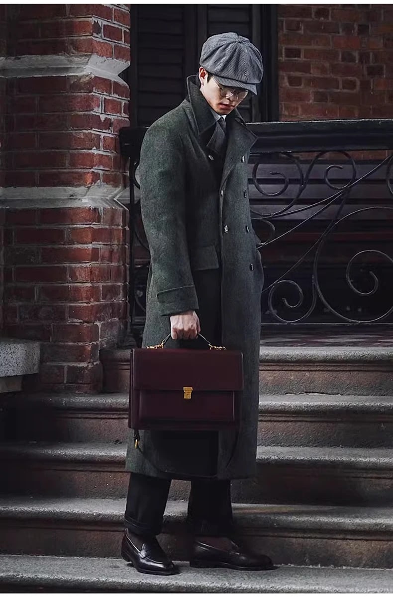 Hartley polo coat in olive, buttoned, with a leather briefcase