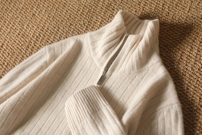 Stand collar and zip of the Sutton cardigan in cream