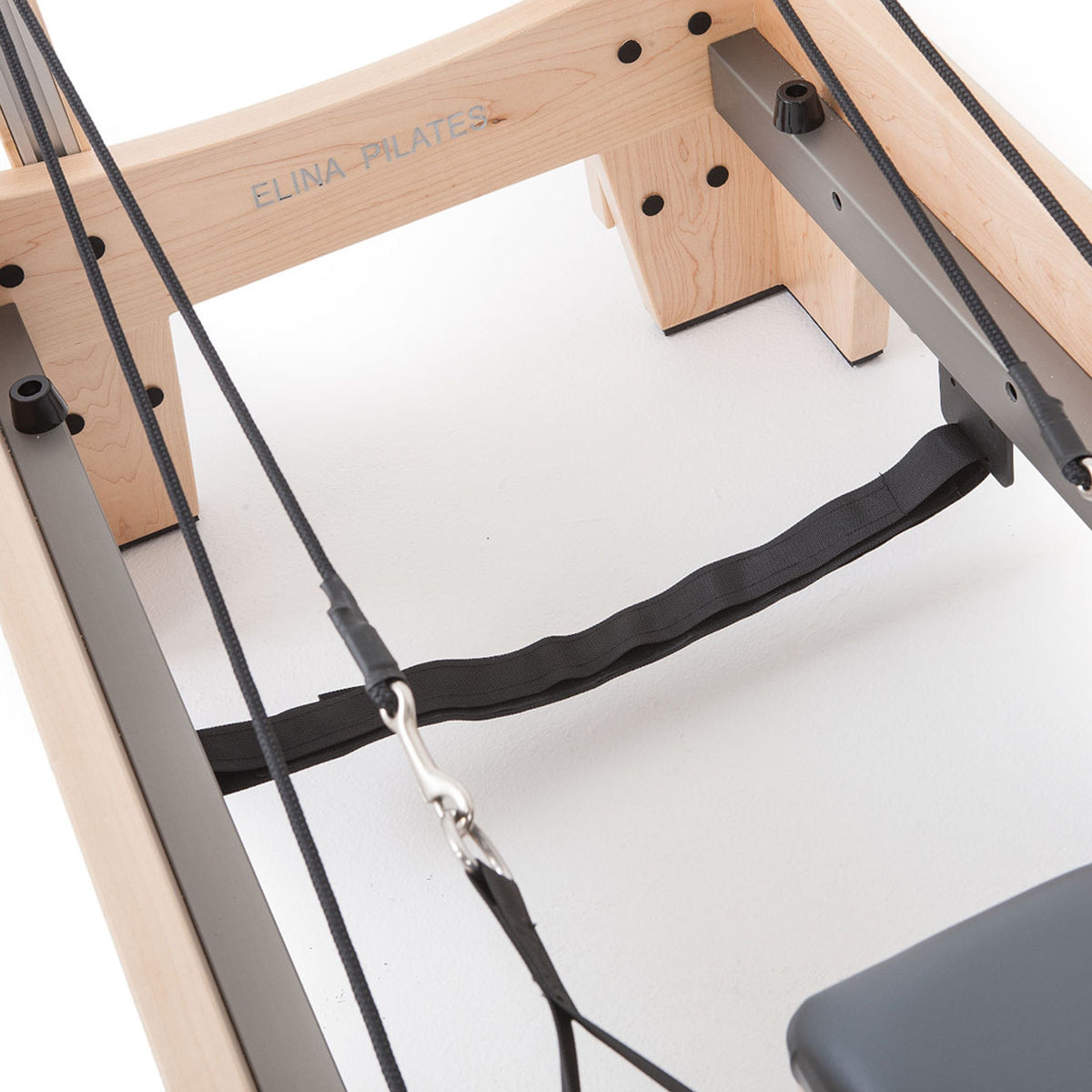 Elite Wood Reformer rope and strap anchor under the frame